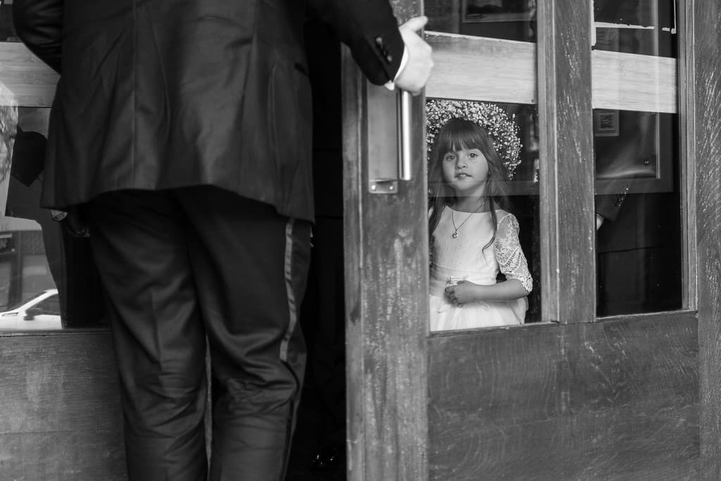 A black and white photograph from behind someone standing in a doorway