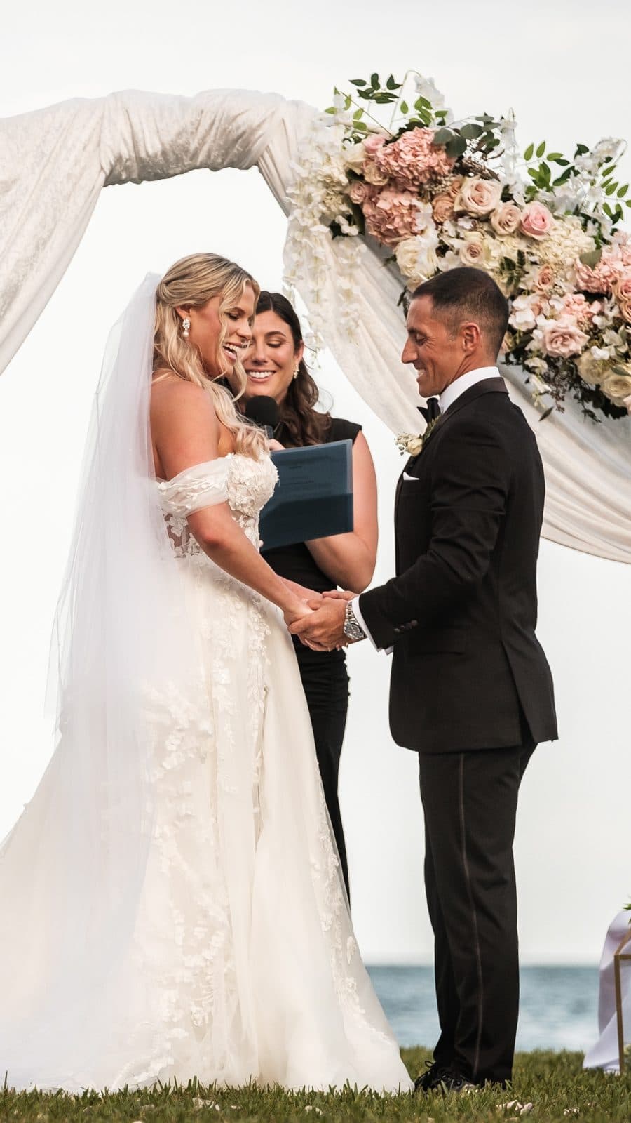Alyssa and Chris walking past a tall arched window