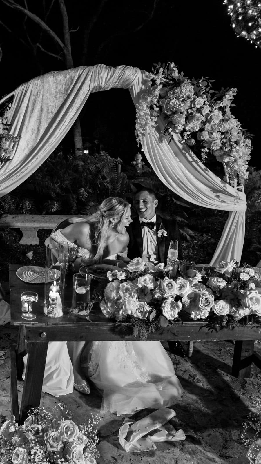 Alyssa and Chris walking together in the reception light