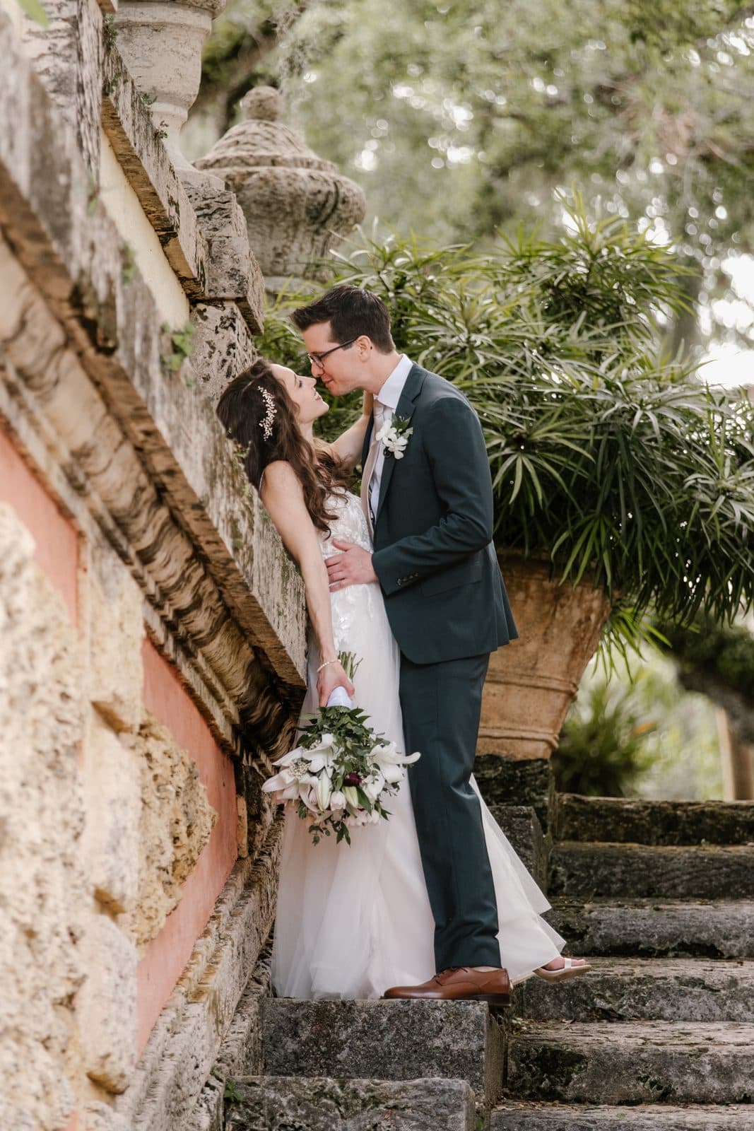 A portrait of Chloe and Michael smiling at Vizcaya