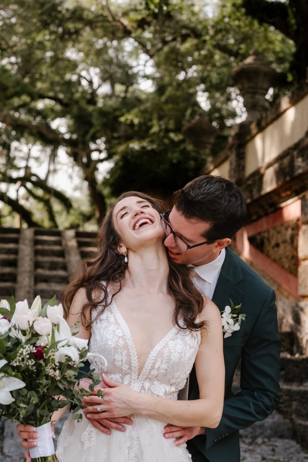 A close portrait of Chloe and Michael under the stonework