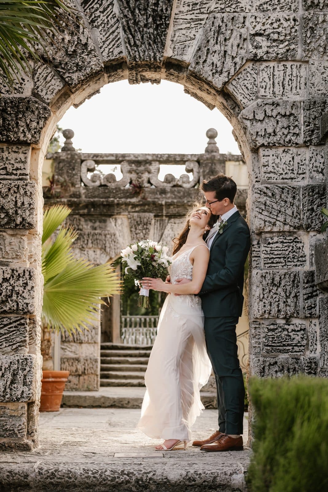 A portrait of Chloe and Michael under an arch