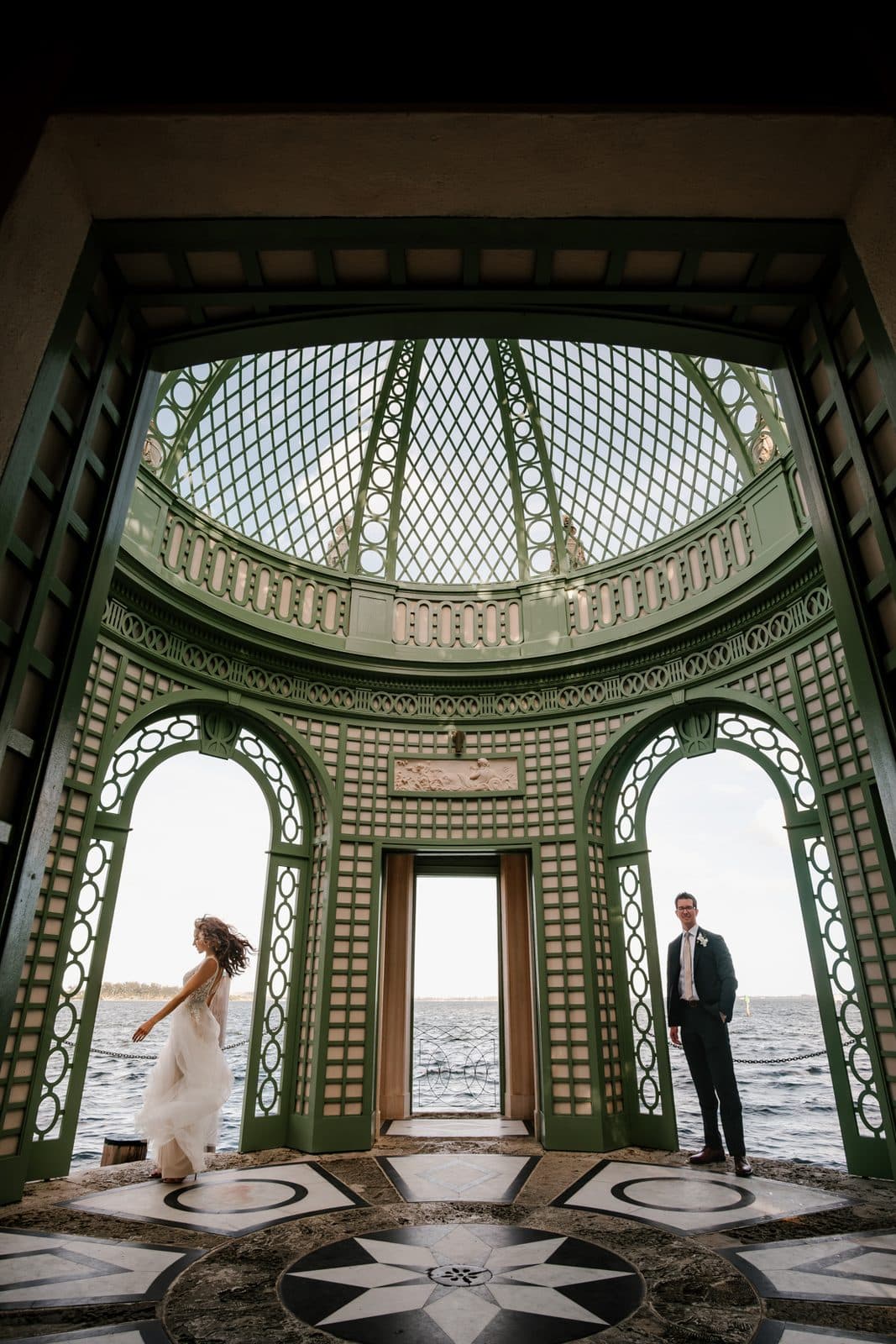 Chloe and Michael framed by repeating stone arches