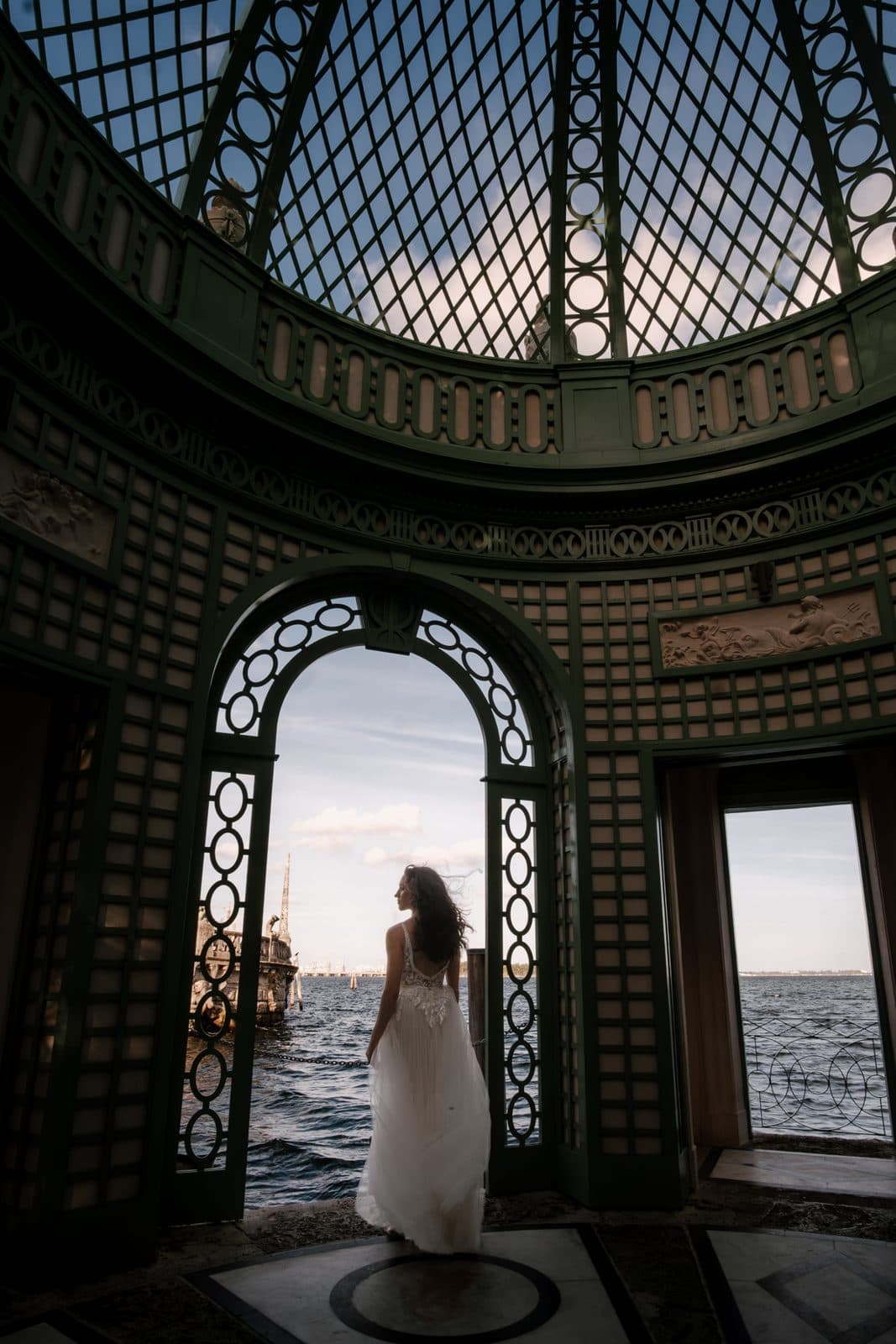 Chloe and Michael from behind, walking the colonnade