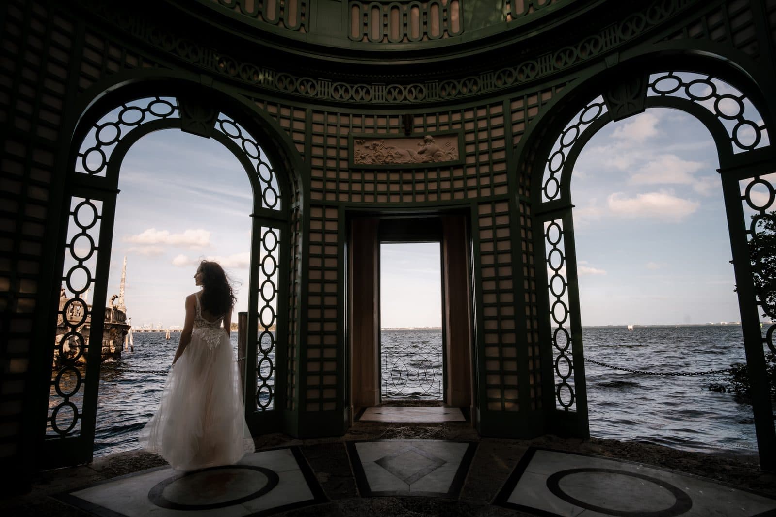 A wide view of Chloe and Michael beneath the arches