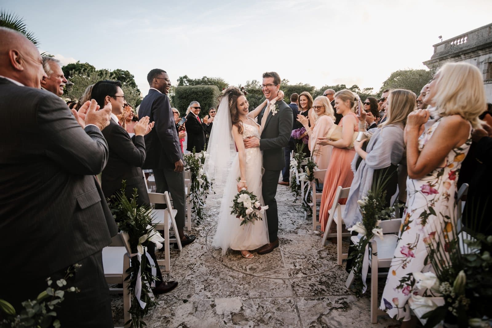Chloe and Michael walking past the mansion
