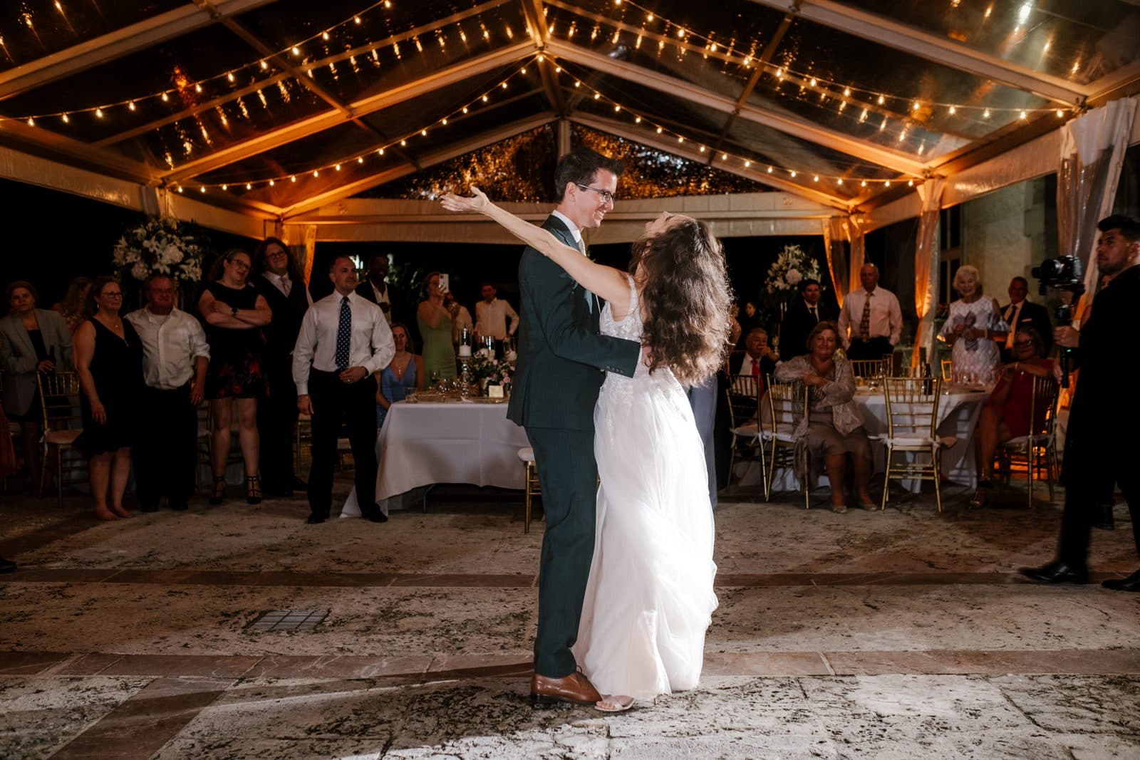 Chloe and Michael on the grounds among palms and stonework