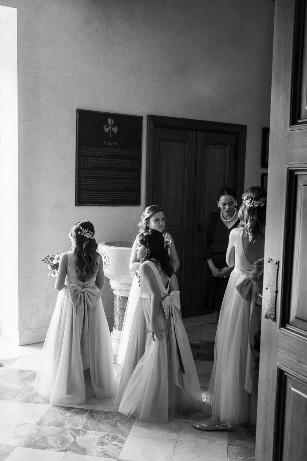 Sophia and Patrick walking down the church steps, her veil trailing