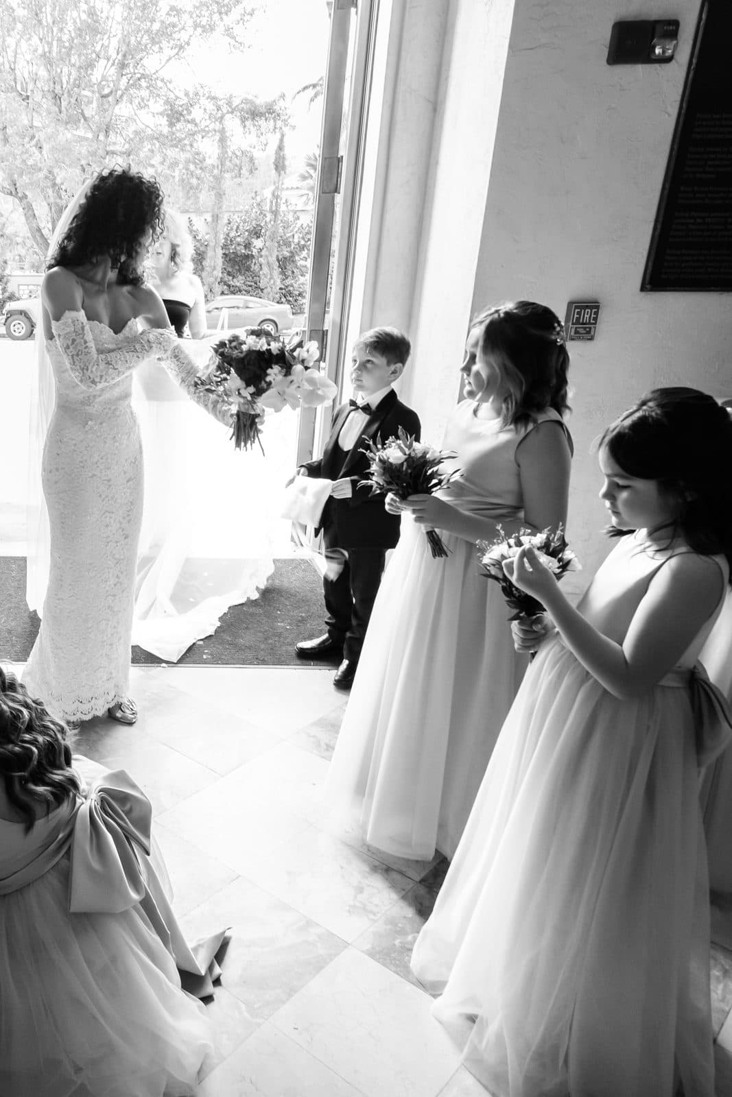 Sophia and Patrick from behind as they walk away, her veil spreading out