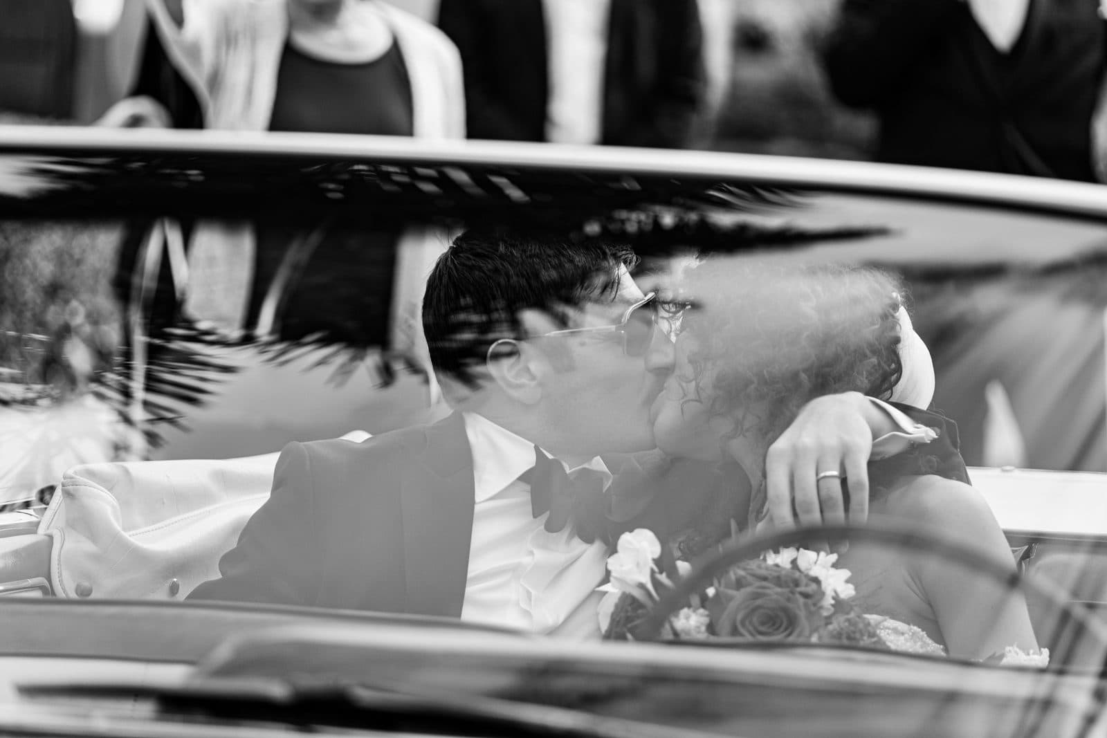Black and white photograph of Sophia and Patrick walking away from the church