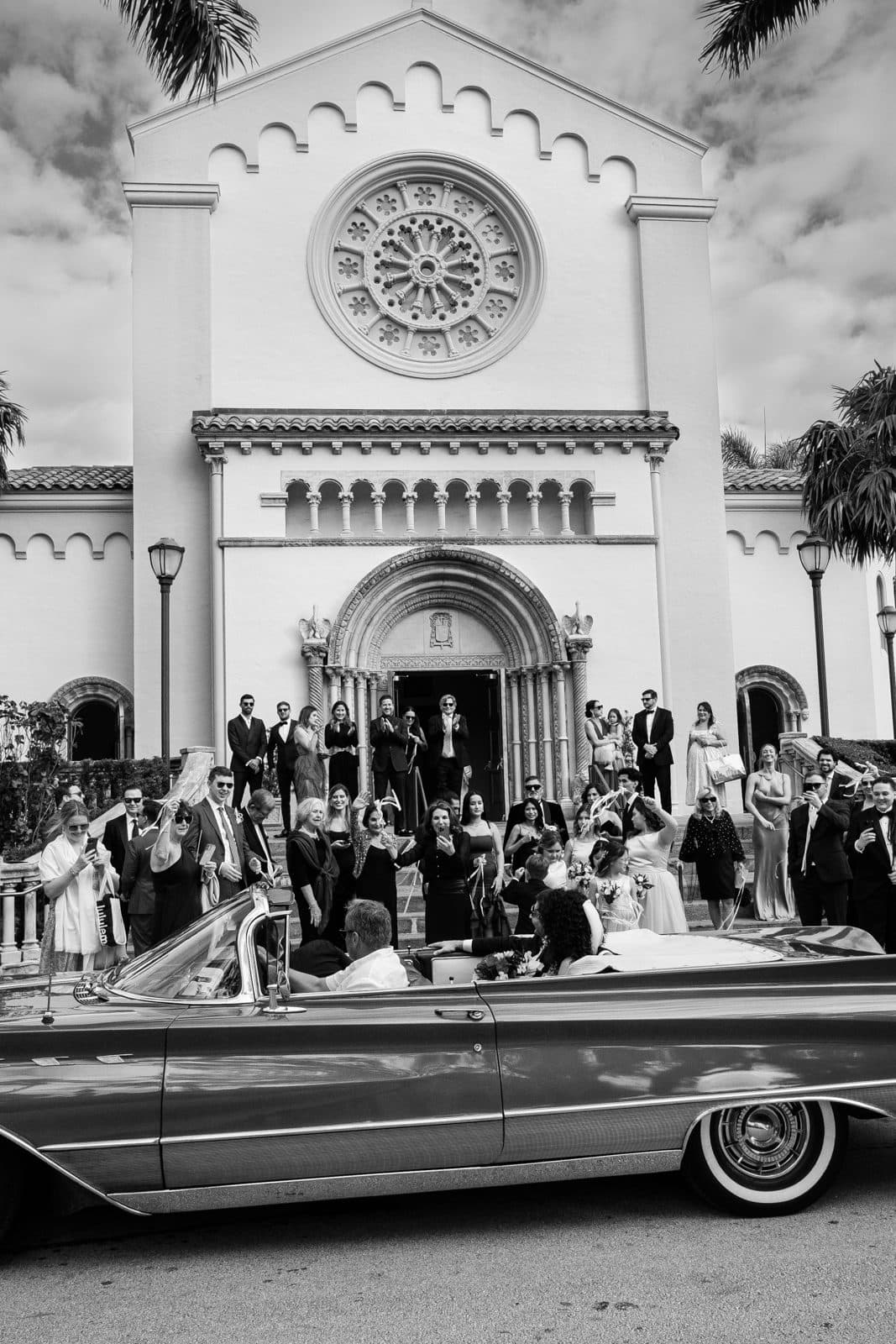 The ceremony in color, with guests standing in the aisle